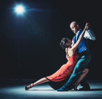 a man and woman dancing in a dance pose