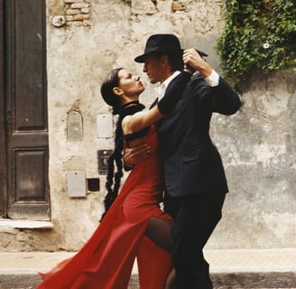 a man and woman dancing in a street