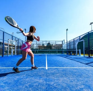 a woman in a pink skirt playing Padel outdoors