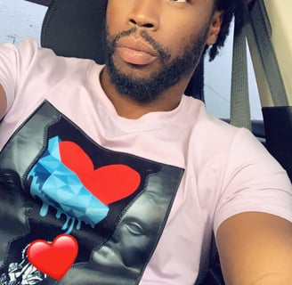 a man with a heart shaped t - shirt on his shirt