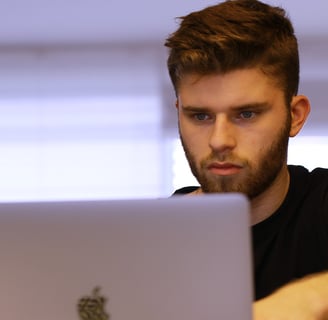 a man sitting at a laptop computer