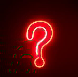 a neon - lit sign with a question mark on it