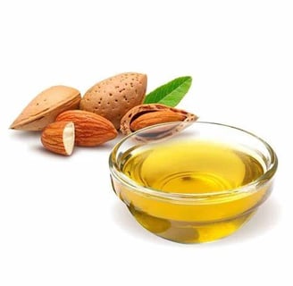 a bowl of almond oil with almonds and almond oil