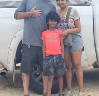 a man and woman standing in front of a truck