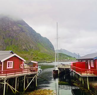 Historic Å fishing village with red cabins and the Jolly Good Times Sailing boat
