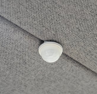 Built-in ceiling-mounted motion sensor on acoustic panel