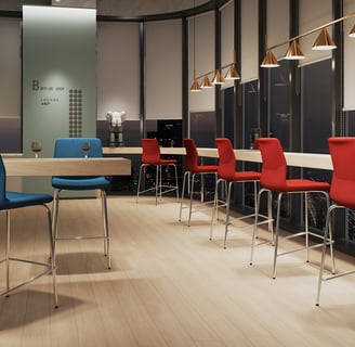 Bar-height blue and red Rita chairs in a modern office lounge with city night view