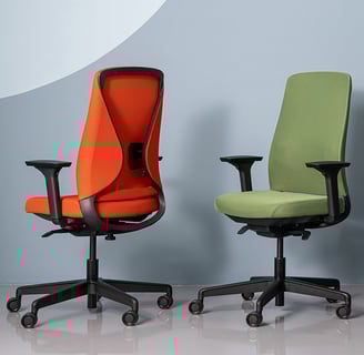 Red and green ergonomic task chairs with mesh backs and adjustable armrests