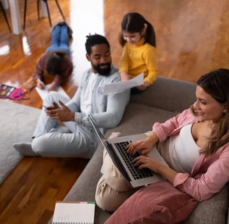 a woman sitting on a couch with her family