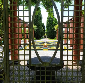 a circular shaped metal gate with a circular mirror