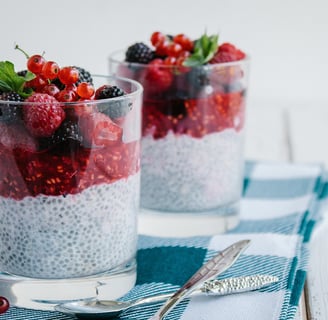 Chia seed pudding with mixed berries and a mint garnish