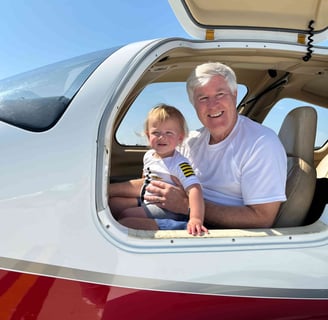a man and a baby in a small plane