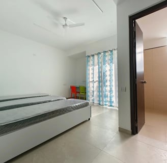 Spacious twin-sharing PG room in Banglore with a balcony, modern furniture, A/C and luxury.