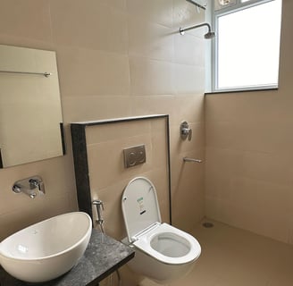 An luxury bathroom with a hot water shower and a designer look