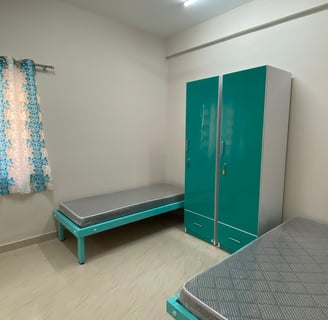 Spacious twin-sharing PG room in Banglore with a modern furniture, A/C and luxury.