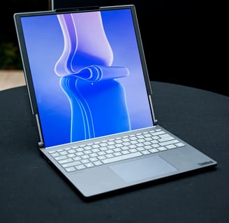a laptop computer sitting on a table with a laptop on it