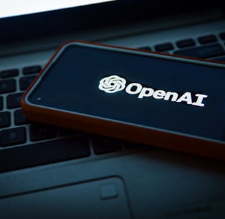a cell phone with an open laptop on a laptop openai