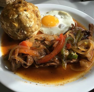 Bolon de verde with fried egg and a meat stew