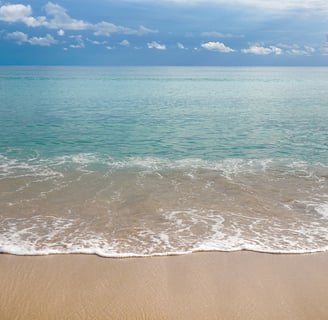 beach with crystal clear water washing on the sand in Playa de Muro Mallorca