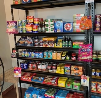 a shelf of food and snacks on a shelf