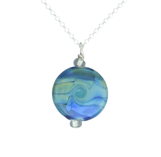 a blue and white glass bead necklace with a blue swirl