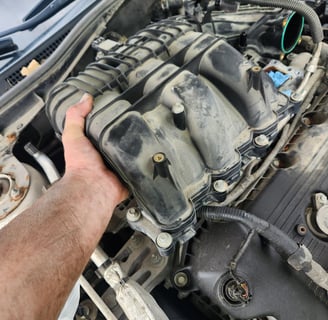 Fast T's Master Tech removing an intake manifold from a Honda accord to replace the intake gasket and spark plugs