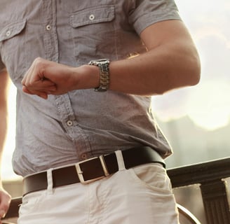 a man in a gray shirt and white pants