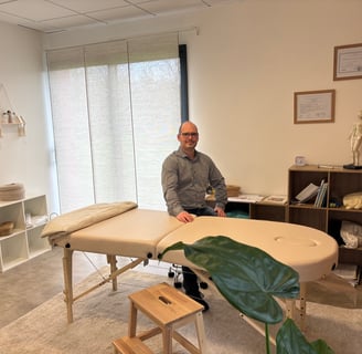 The patrician in front of his massage table in his office