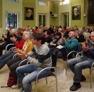 a group of people sitting in chairs in a room