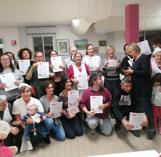 a group of people holding up certificates and holding up certificates