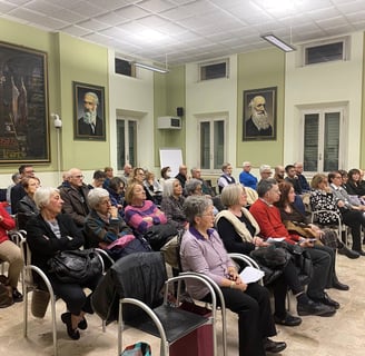 a group of people sitting in chairs in a room