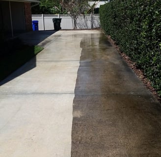 a drive way one half of it has been pressure washed the other is still dirty comparison photo