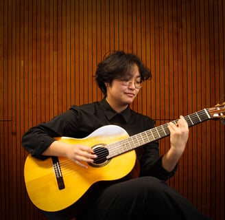 a woman playing a guitar in a room