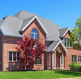 Grand brick home with beautiful landscaping