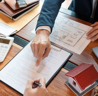 Realtor showing a client information on a contract