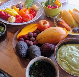 a table with bowls of fruit and vegetables