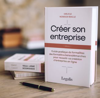 a book with a pen and a pen on a table LEGALIS