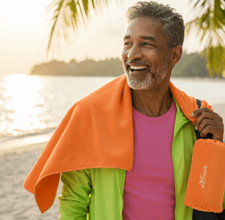 A scenic view of a tropical beach with crystal-clear water, and a traveler relaxing