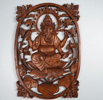 a wooden carving of a ganesha