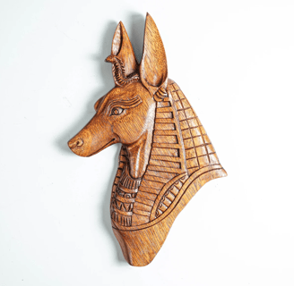 a wooden wall mounted head of an egyptian Anubis