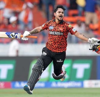 a man in a red shirt and a helmet on a field