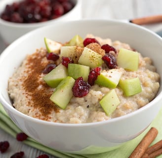 a bowl of oatmeal with apples and cinnamon