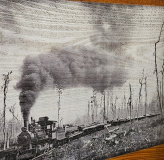 a black and white photograph of a train engine on wood