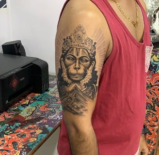 Realistic Hanuman face tattoo in black and grey on shoulder by Dudo’s Tattoos in Hyderabad