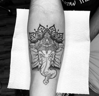 Black and Grey Ganesha tattoo with mandala design by tattoo artist at Dudo’s in Hyderabad
