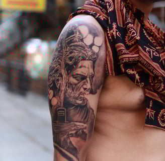 Realistic Shiva face tattoo on shoulder by Dudo’s Tattoos and Piercing in Hyderabad