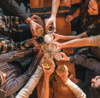 a group of people at the Riga Pub Crawl standing around a table with beer glasses