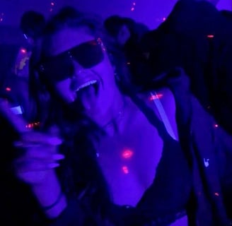 a woman in a black bra top and sunglasses during the Riga Pub Crawl