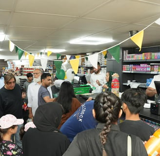 customers being served inside a busy convenience shop