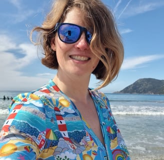 a woman in a colourful hand crafted shirt and sunglasses 